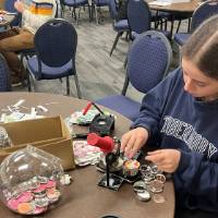 Thompson Scholar makes buttons from seed packets